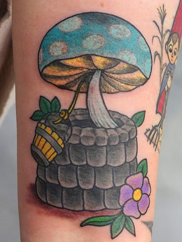 Tattoo of Blue mushroom in a wood bucket