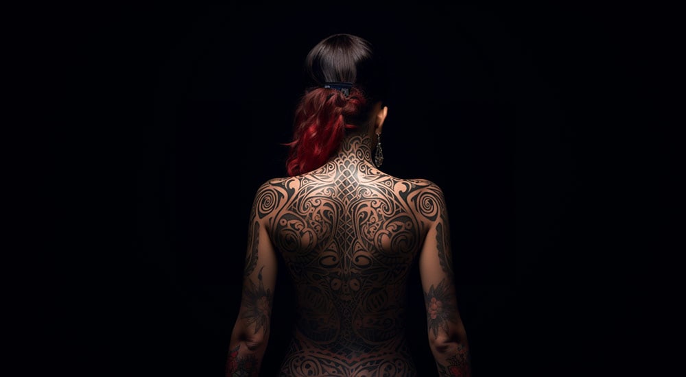 A woman's back covered in tribal tattoos