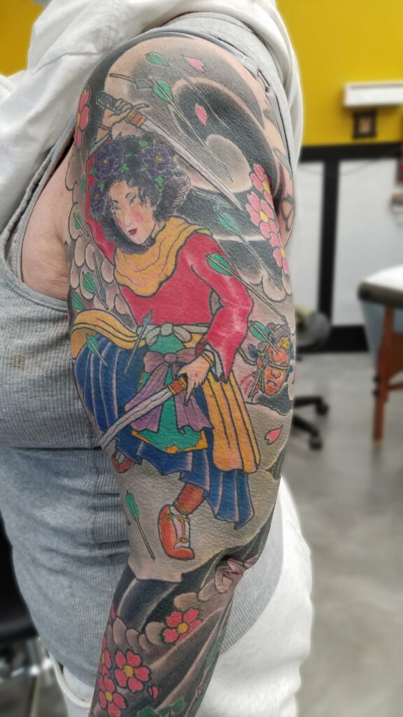 Traditional japanese sleeve with blossoms waves and fighting goddess