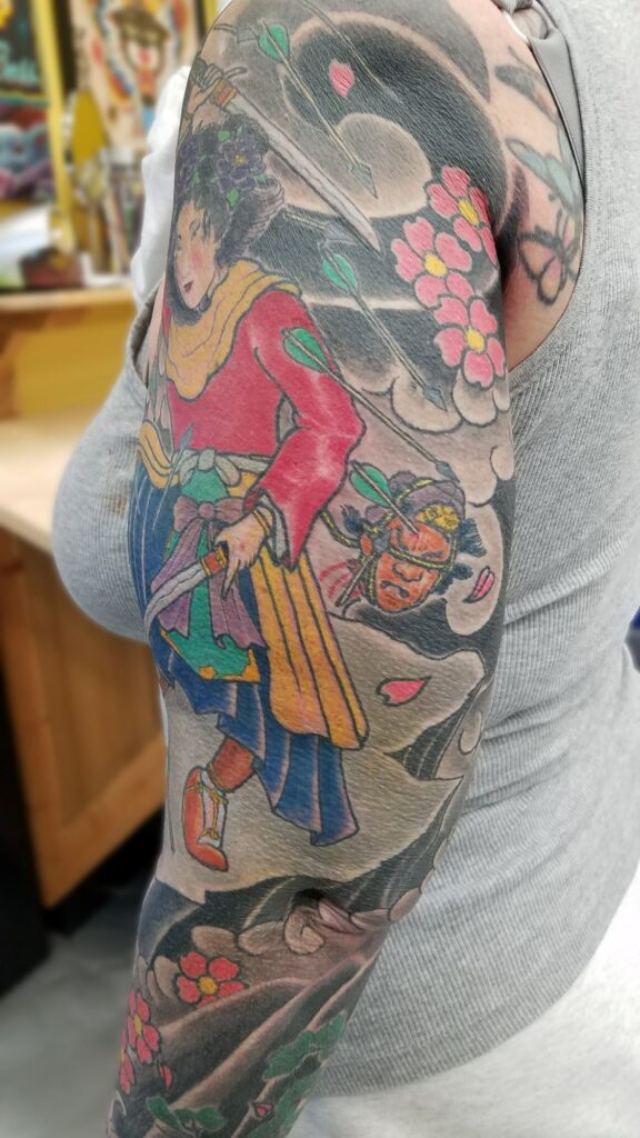 Traditional japanese sleeve with blossoms waves and fighting goddess