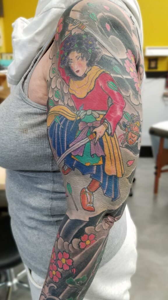 Traditional japanese sleeve with blossoms waves and fighting goddess