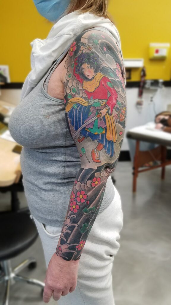 Traditional japanese sleeve with blossoms waves and fighting goddess