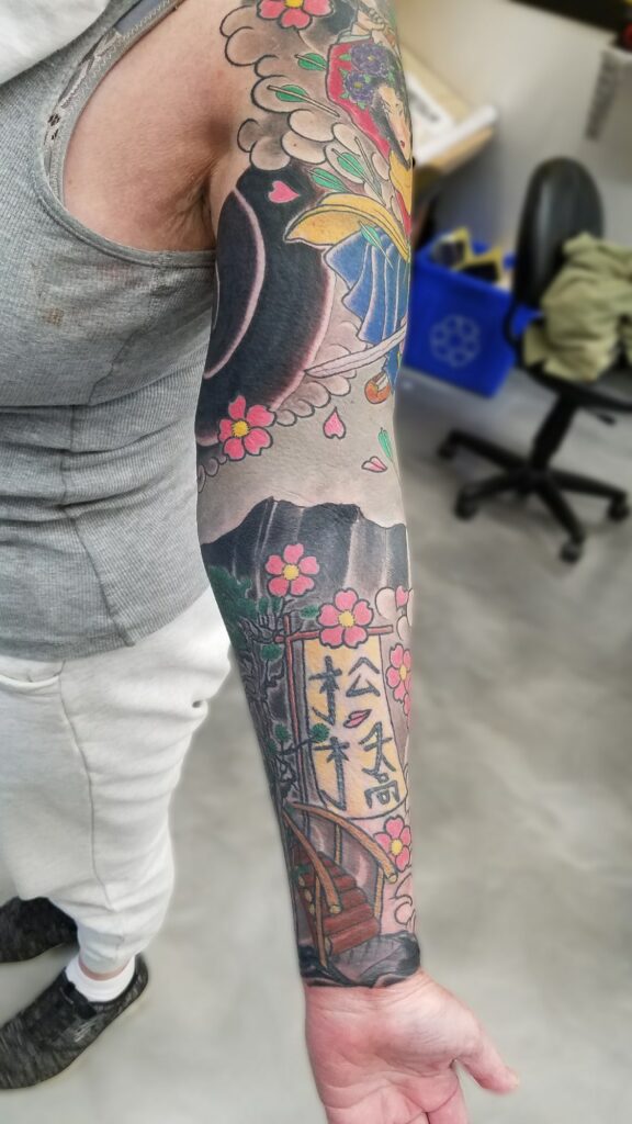 Traditional japanese sleeve with blossoms waves and fighting goddess