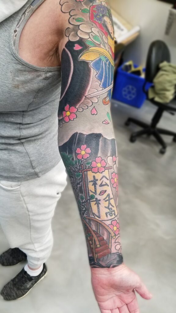 Traditional japanese sleeve with blossoms waves and fighting goddess