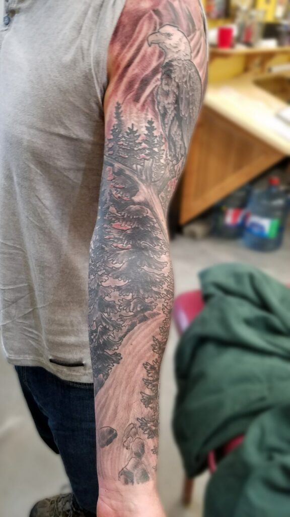 Eagle, trees and wilderness tattoo